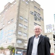 Ipswich Borough Council leader David Ellesmere outside the former R&W Paul silo