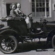 Jeanne Bowker in a rally car outside the Magpie Hotel during the early 1950s