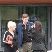 Joshua Joyce leaves court with his grandmother and defence solicitor, Philippa Beswick, in August