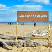 The artwork 'You are sea glass' created on Southwold beach by Adam Bridgland