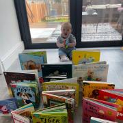 A happy baby with Let's Talk Reading gifted books.