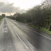 Car crashes into a wall and overturns.