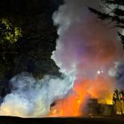 Smoke billowing from a car on fire