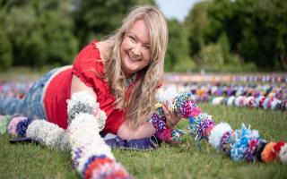 Brandon Yarn Bombers have created over thirty one thousand pom poms in an attempt to break the world record for the longest line of pom-poms. One of the organisers, Claire Watts.